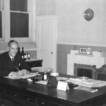 Albert Robert Hayward co-founder with his brother Edwin shown working at his desk November 1950